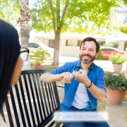 Interpreter using sign language during conversation outdoors.