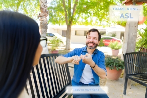 Interpreter using sign language during conversation outdoors.