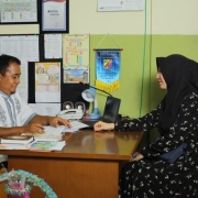 Parent and school staff member reviewing IEP documents during a meeting