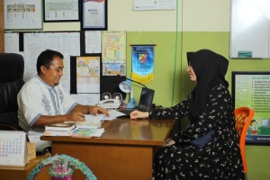 Parent and school staff member reviewing IEP documents during a meeting