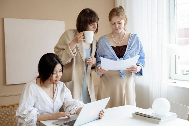 Team comparing a printed document against an on-screen translation
